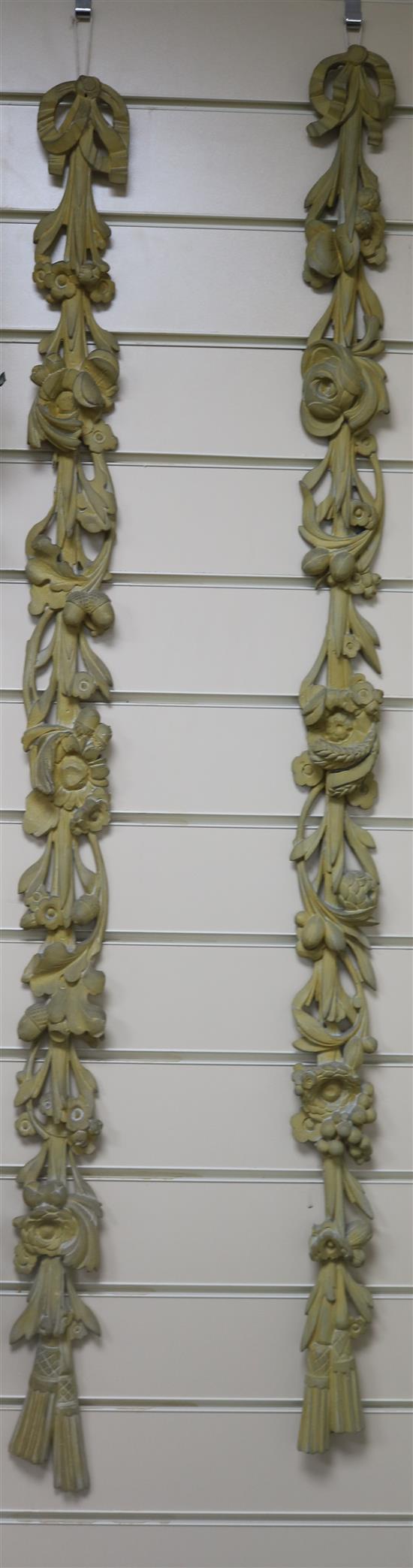 A set of 4 carved wood appliques 118cm.
